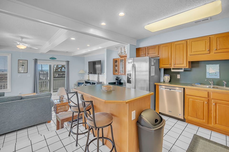 Your spacious oceanfront kitchen features granite counters, stainless appliances, and breakfast bar seating for casual meals.