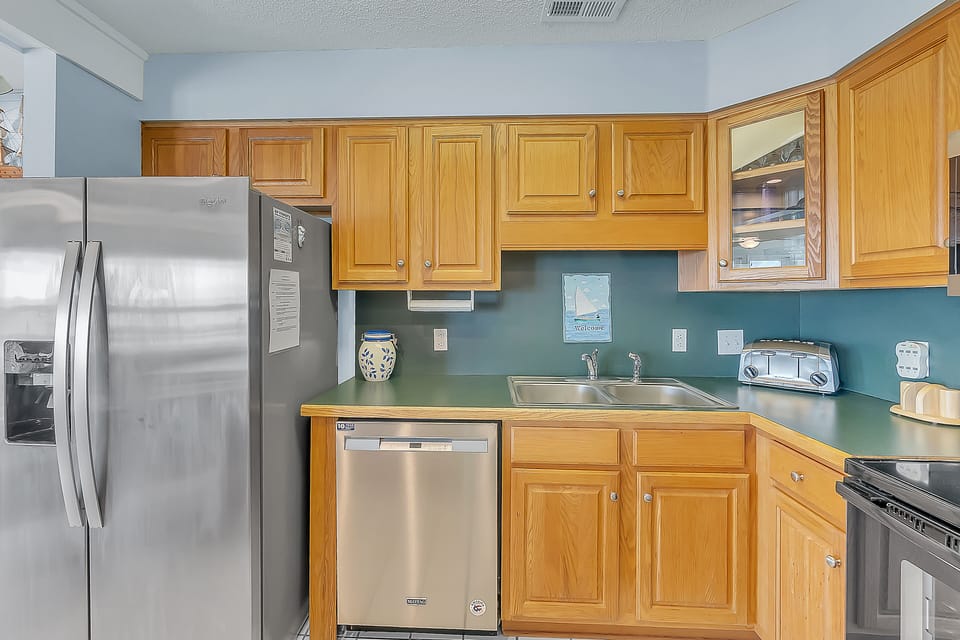 Your fully equipped kitchen features warm wood cabinets, stainless appliances, and everything you need to prepare memorable meals during your stay.