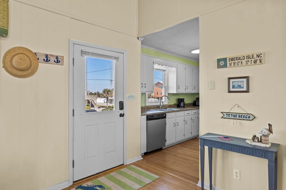 Cozy coastal kitchen with beachy charm, where you'll find everything needed for meals plus charming nautical touches throughout your stay.