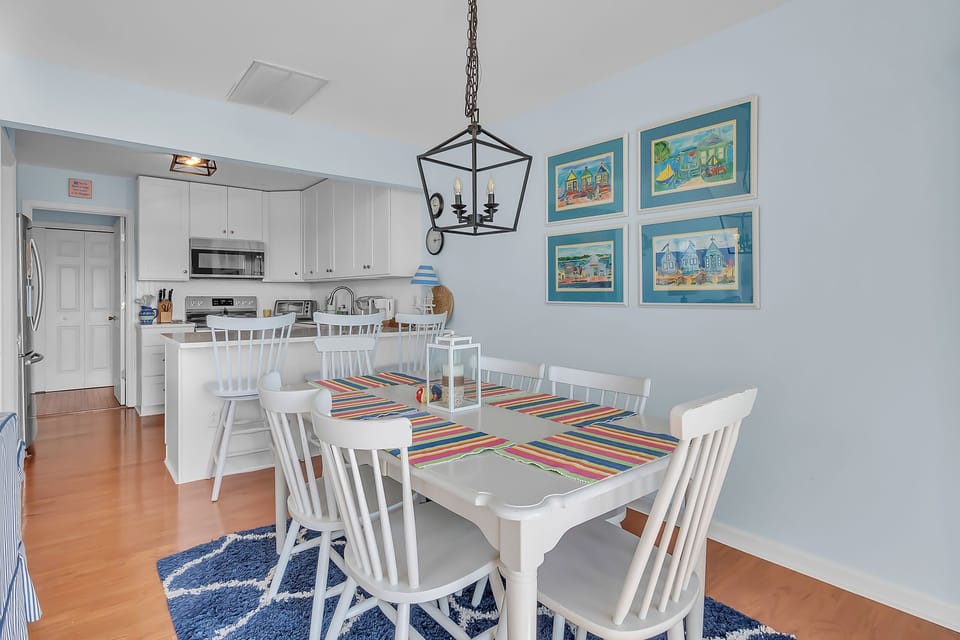 Gather around your bright dining table for meals and morning coffee in this cheerful coastal-themed space.