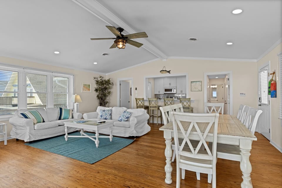 Relax in your spacious coastal living room with comfortable seating and open dining area, perfect for gathering with loved ones.