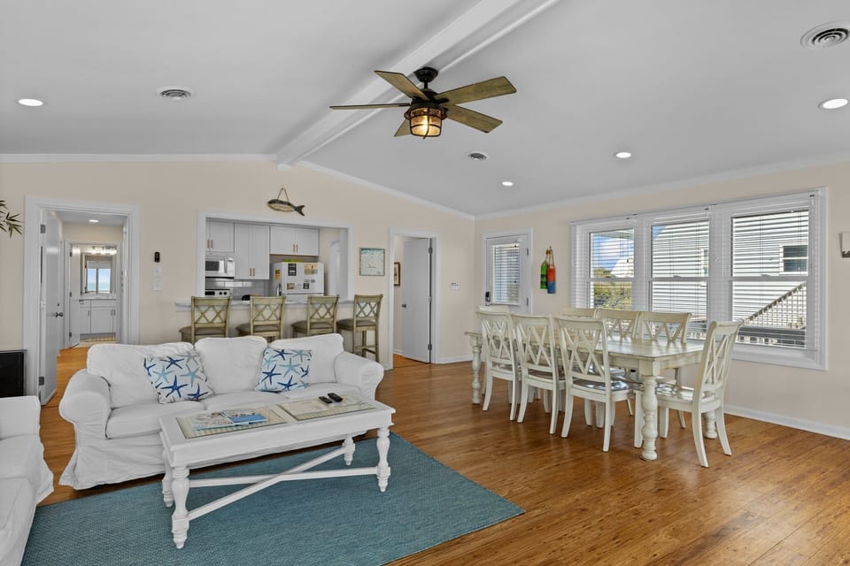 Relax in your bright, coastal-inspired living space with comfortable seating, dining for eight, and an open kitchen perfect for gathering.