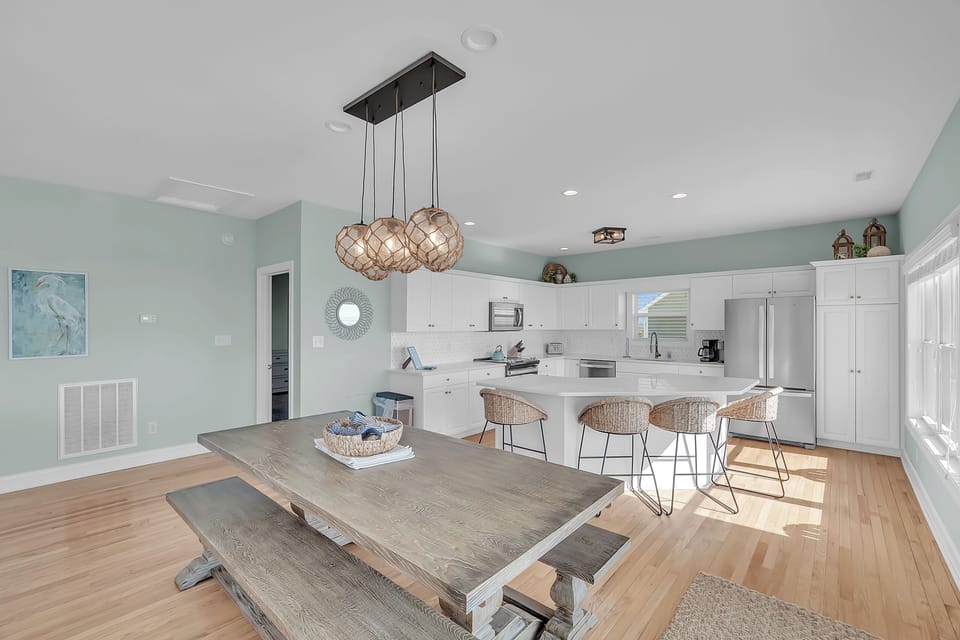 Gather around your spacious dining table where coastal hues meet modern comfort, creating the perfect space for memorable meals together.
