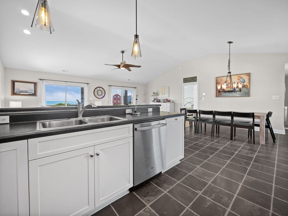 Your fully-equipped kitchen features sleek granite counters and stunning ocean views, perfect for cooking memorable meals together.
