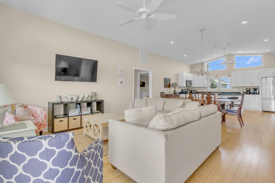 Relax in your spacious living room with comfortable seating, entertainment center, and open flow to your fully equipped kitchen and dining area.