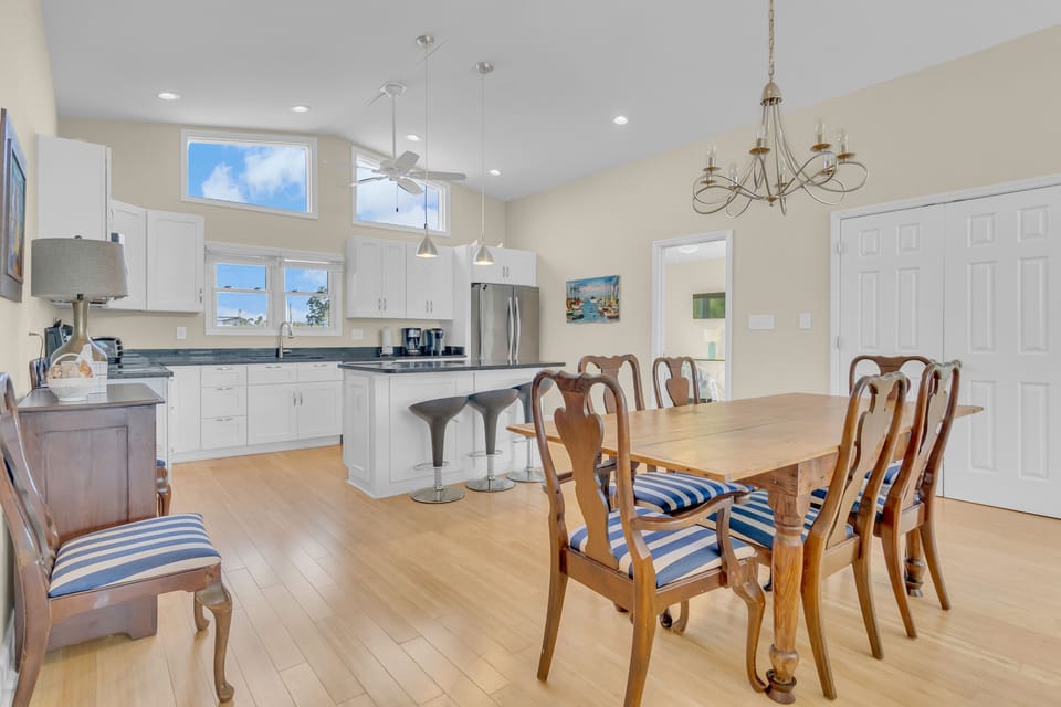 Your open kitchen and dining space features elegant hardwood floors, modern appliances, and charming nautical touches for memorable family meals.