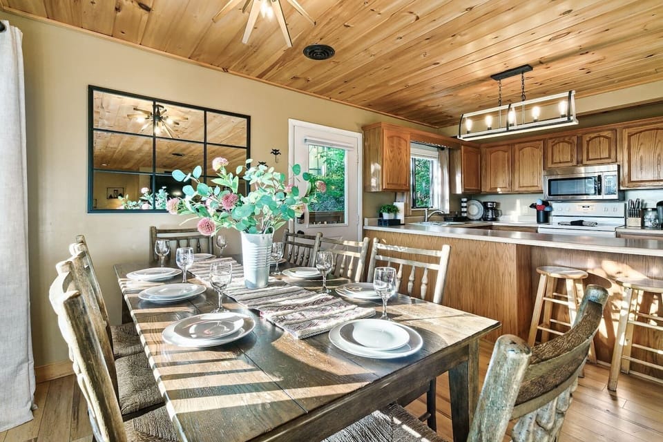 Dining area is on the main level and open to the kitchen. A brand new wood dining table with live edge and seating for 10 has recently replaced the table pictured here.