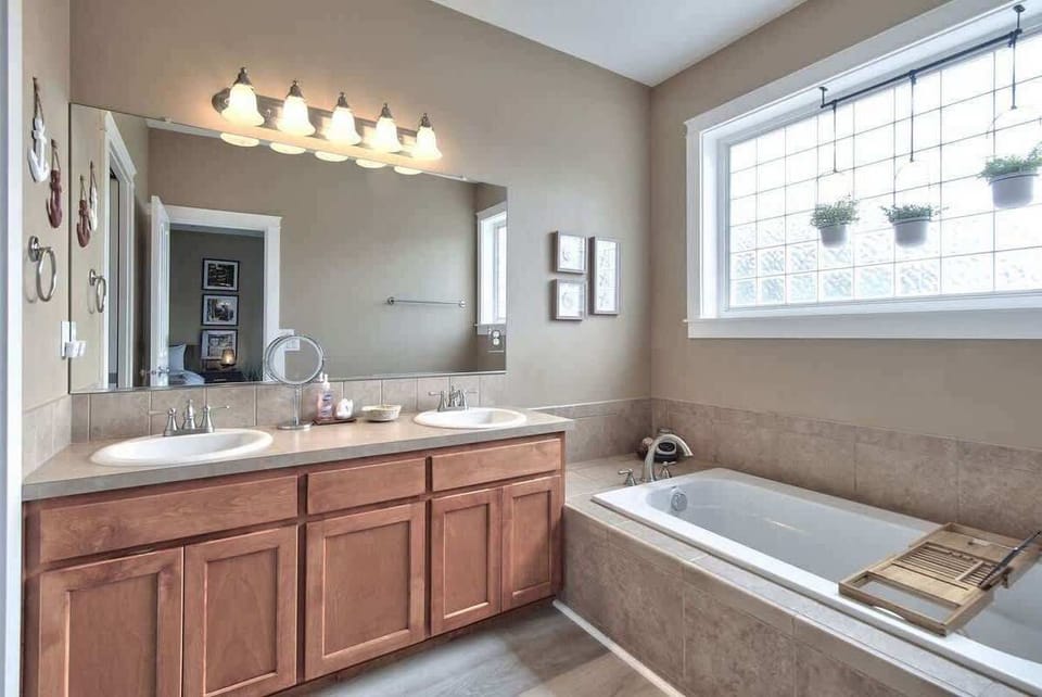 The spacious ensuite bathroom features dual vanities, a soaking tub, and plenty of room to prepare for the day.