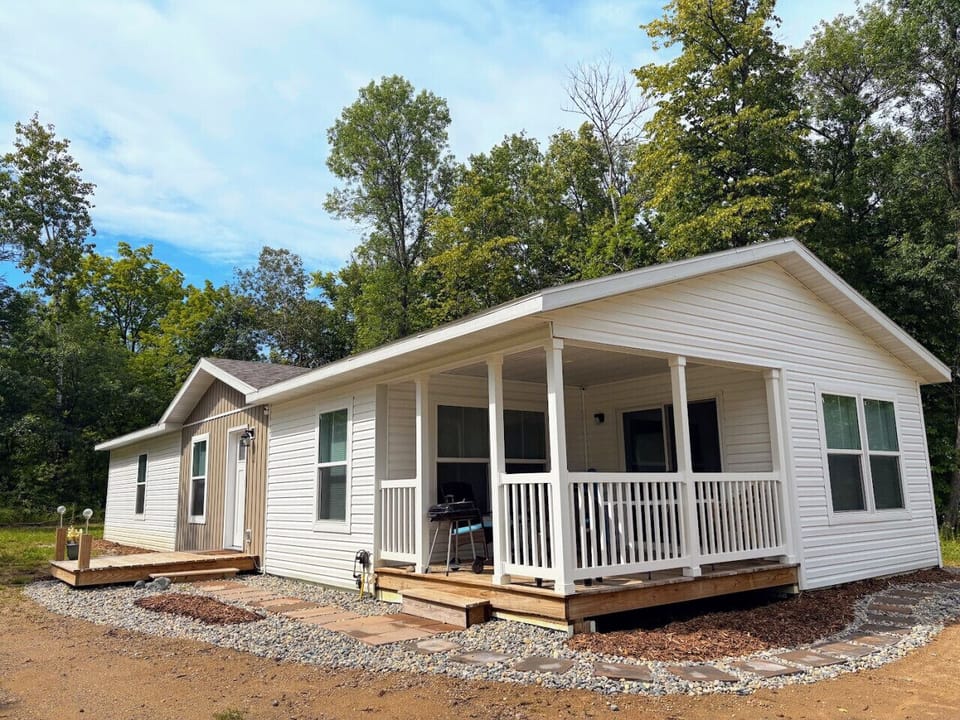 Exterior Sanctuary: Charming deck for sunny afternoons and wooded views, just steps from nature!