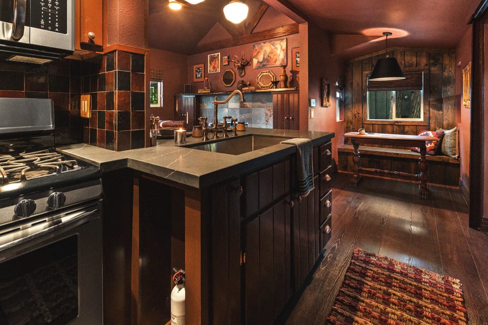 The open concept kitchen - dining - living area makes the tiny cabin feel more spacious. 