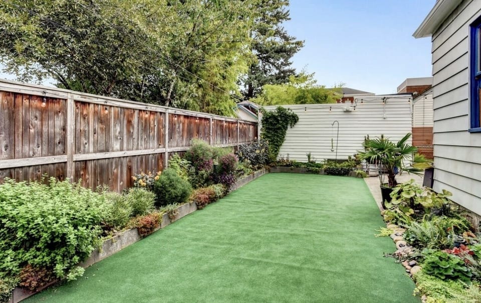Other view of backyard (patio on the right with table and seating for 4)