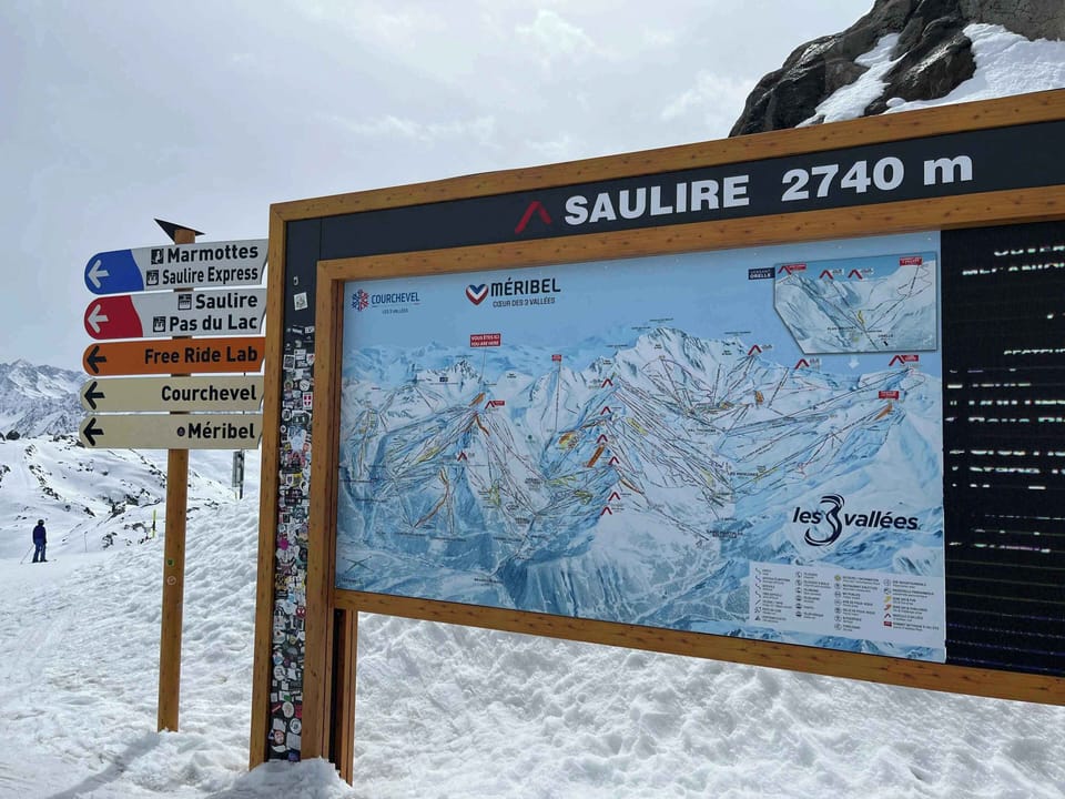 Trail map and directional signage at Saulire summit, 2,740m, within the Les 3 Vallées ski area.