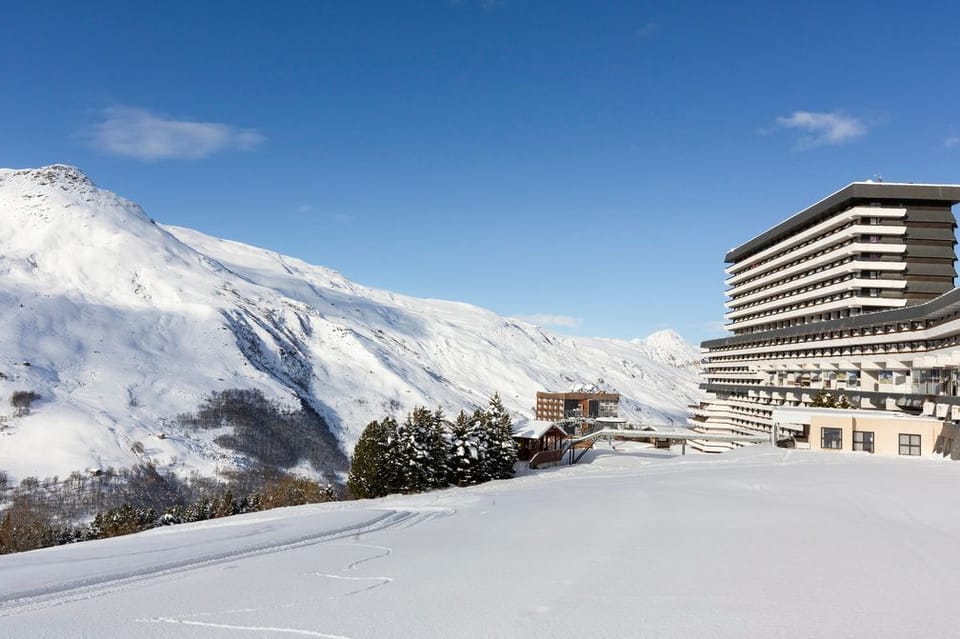 Snow-dusted rooftops and the Trois Vallées peaks behind — the slopes are a short ride from the front door.