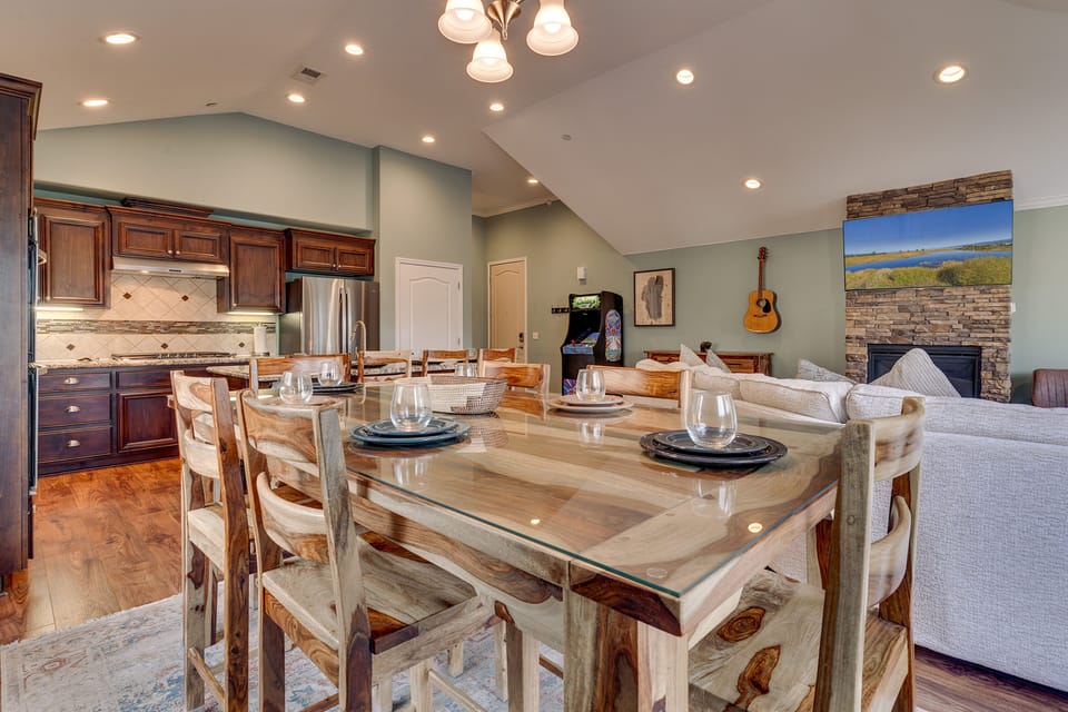 - Dining table beside full kitchen space  
- Entertainment with cozy fireplace nearby  
- Vacation rental perfect for gatherings