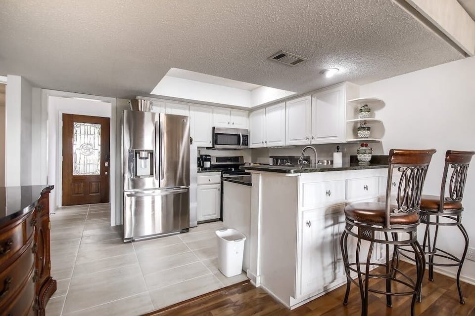 The kitchen is on the entry-level, Attached to the living room, dining room, and balcony.