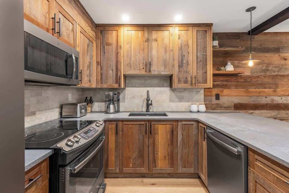 - Cook in style with rustic wood cabinetry and lighting  
- Stainless steel appliances and sleek stone counters  
- Perfect blend of modern comfort and alpine charm  
