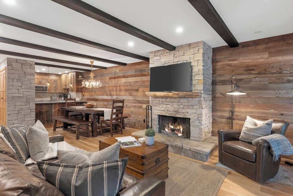 - Open living space with rustic wood and stone details  
- Watch movies or unwind beside the glowing fireplace  
- Ideal mix of warmth, comfort, and Whistler charm  
