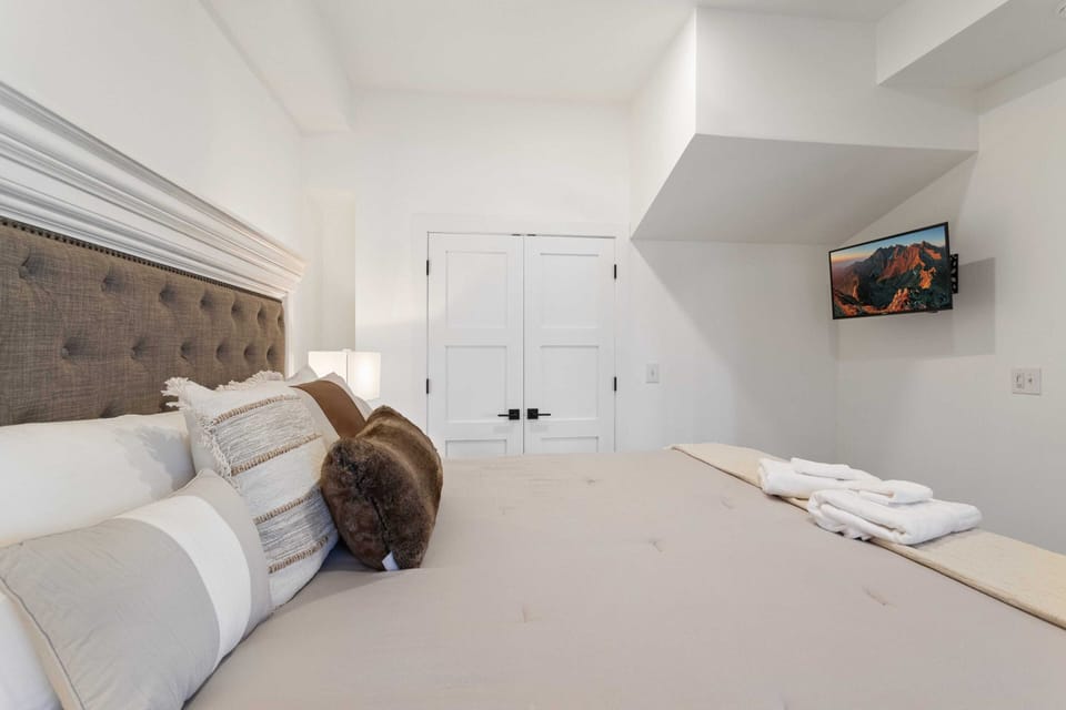 King Bed, TV, and Ensuite Bathroom in the Lower Level Master Bedroom