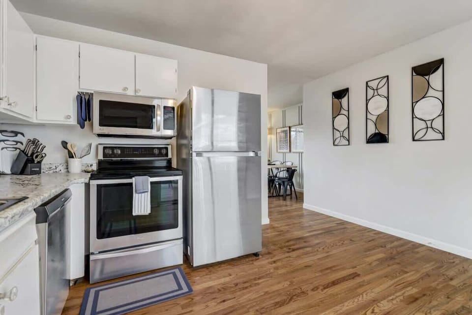 Seamless Living! Our fully equipped kitchen is strategically placed for your convenience, adjacent to the dining area and living room. Enjoy comfort and convenience throughout your stay!