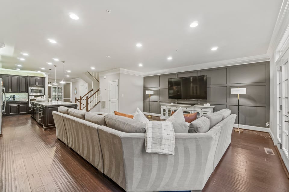 Living area with plenty of comfortable seating and a giant TV