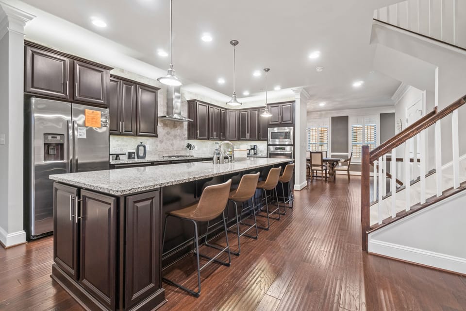 Large, well-stocked kitchen with stainless steel appliances