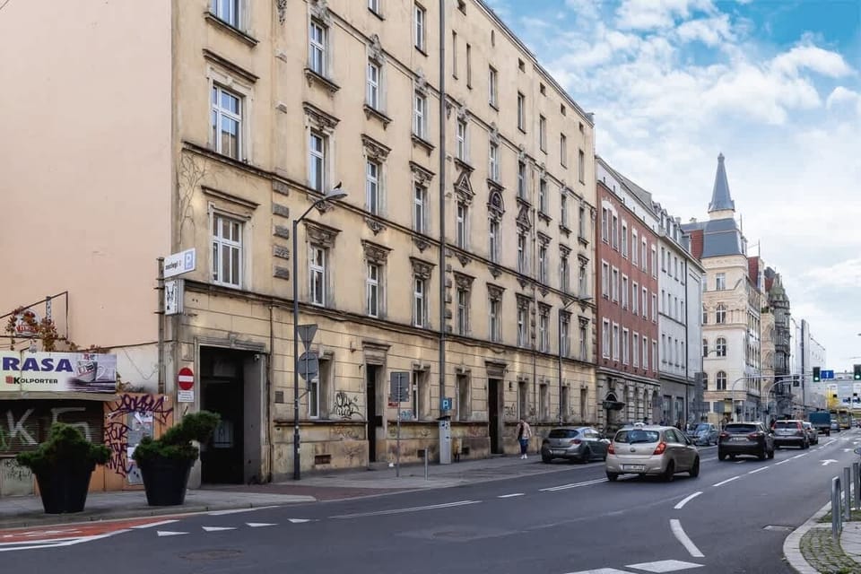A street view of a European city, showcasing historic architecture and a quiet road.

