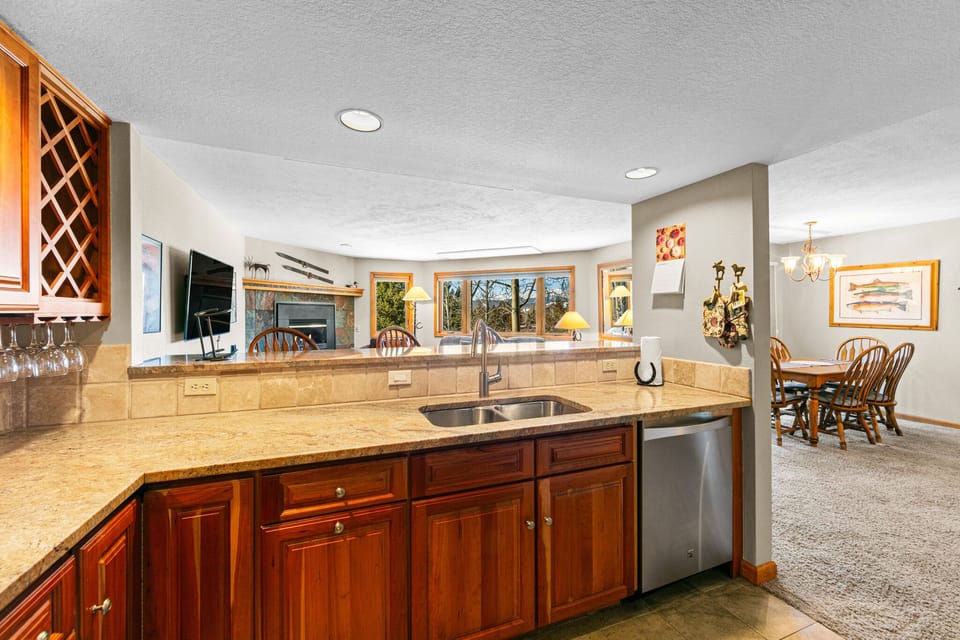 Your fully equipped kitchen flows seamlessly into the dining area, perfect for preparing meals while staying connected to your group.