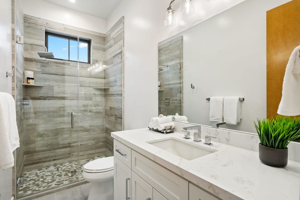 Start the day in the glass shower and bright vanity
