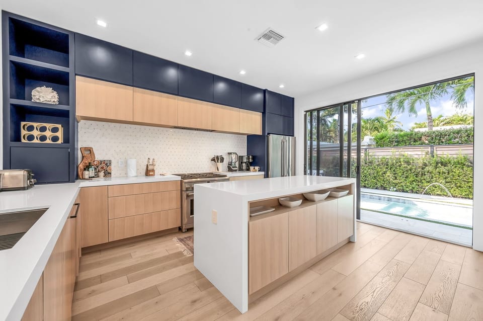 This professionally designed chef's dream kitchen is equipped with high-end GE Cafe stainless steel appliances, custom built cabinetry and a 10’ island