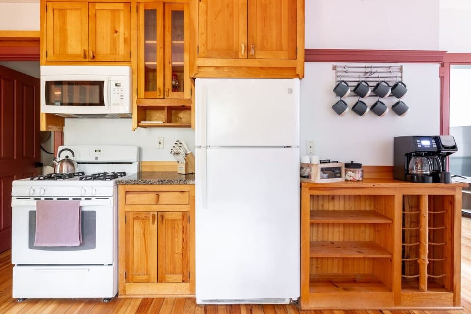 Well-stocked kitchen with a gas stove, microwave, coffee station, and ample storage.