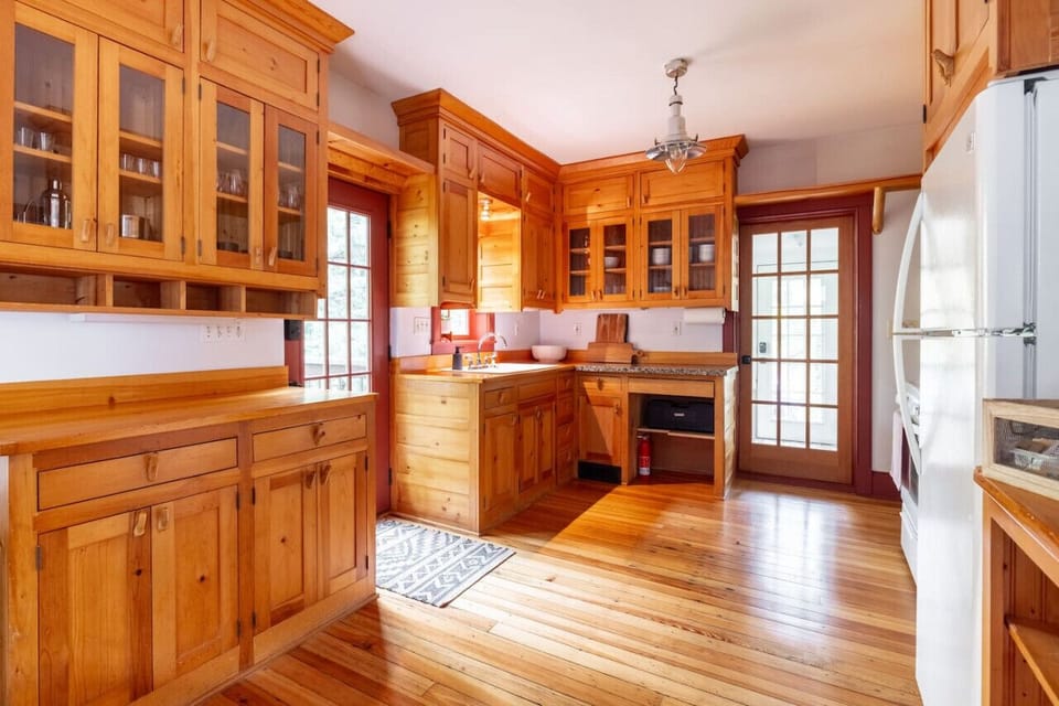 Spacious kitchen with rich wood cabinetry, plenty of counter space, and natural light.