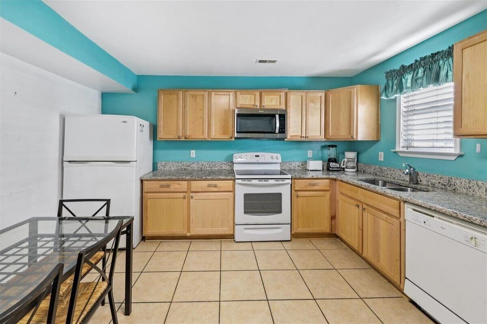 Warm wood cabinets & tons of countertop space in the spacious Kitchen.