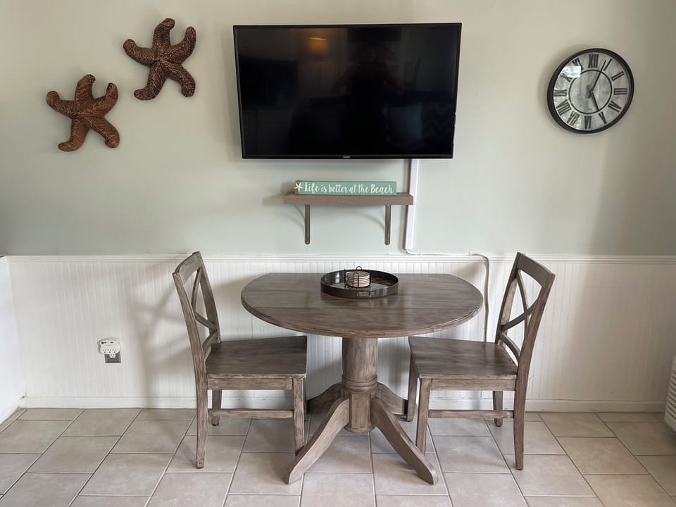 Table with drop-down leaf and extra seating for 4, plus TV trays in closet