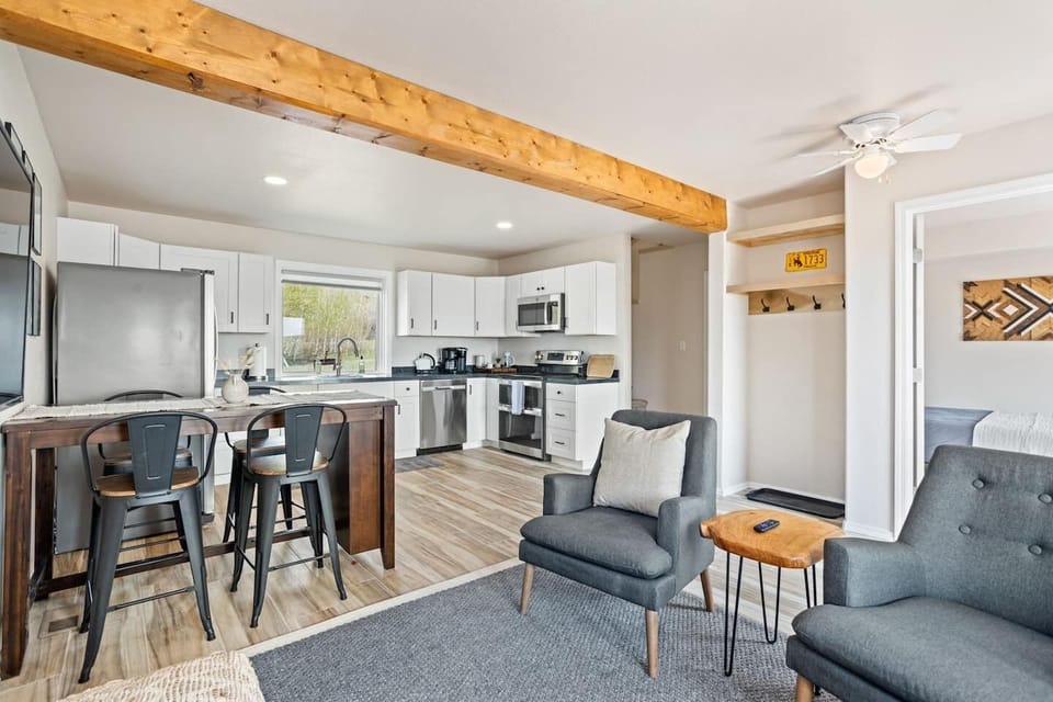 Find the stairs to the master suite in the open doorway next to the kitchen.