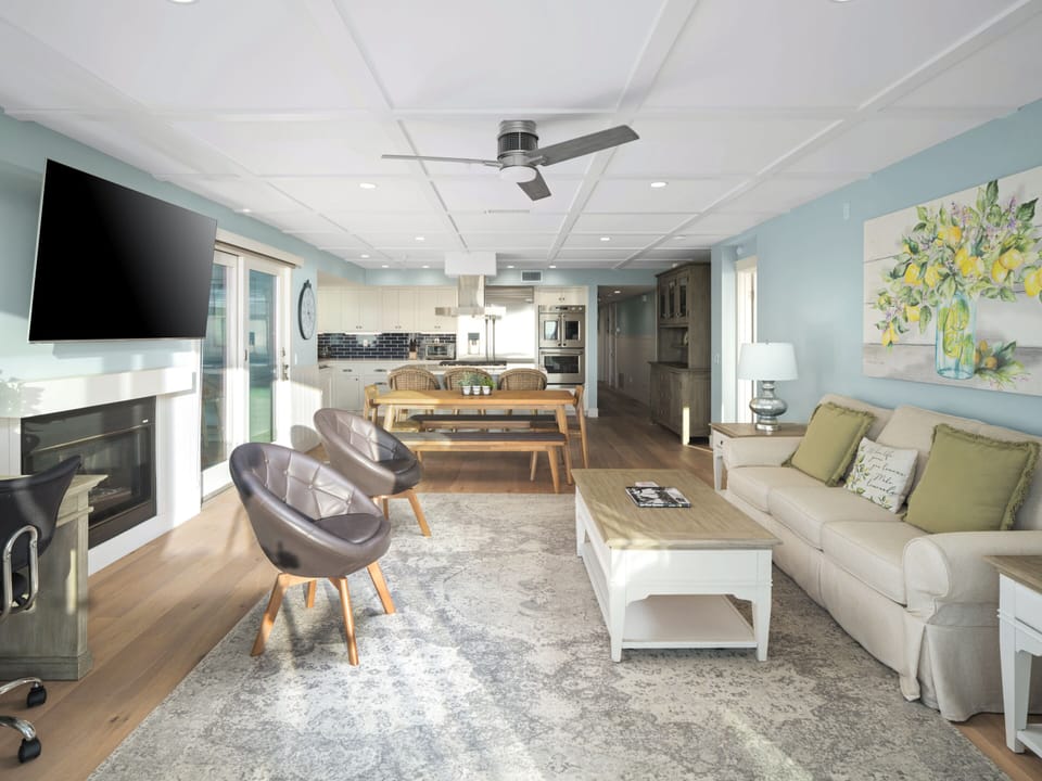 In soft tones of blue, cream, and yellow, this bright yet serene living space features chic, cheerful décor that invites you to relax and unwind.