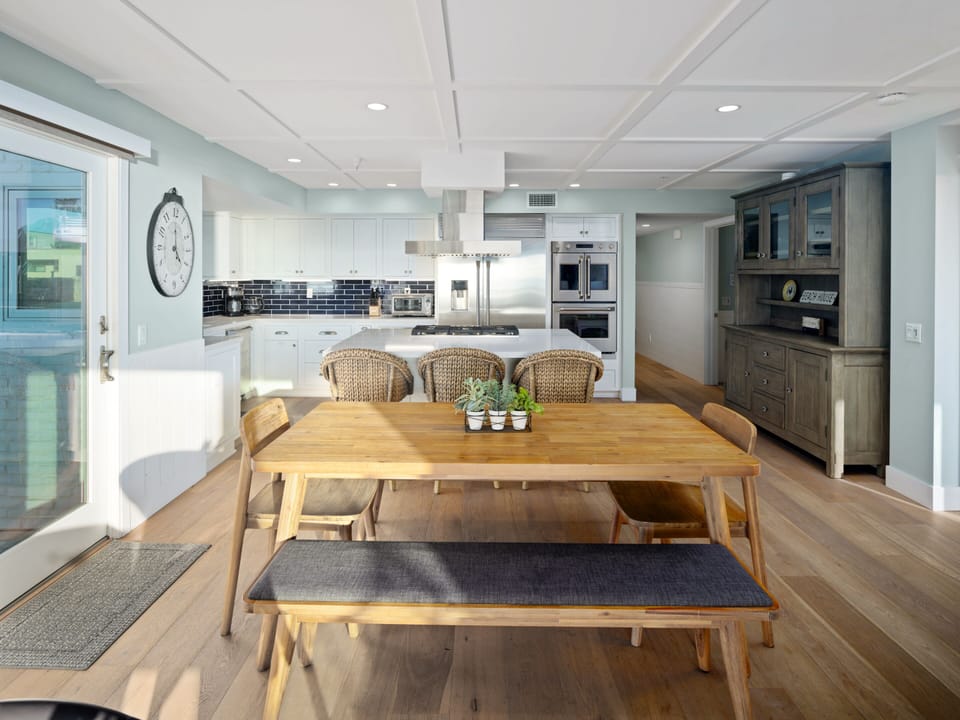 This natural wood table provides ample space for a comfortable and enjoyable dining experience.