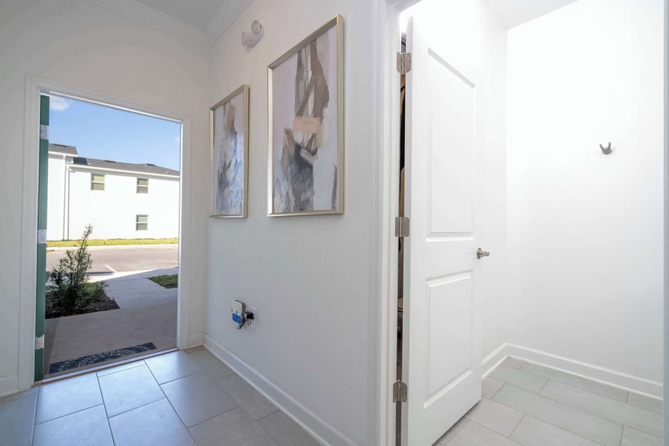 Walk through a modern hallway filled with natural light and elegant décor — connecting every part of the home with a warm, welcoming feel.