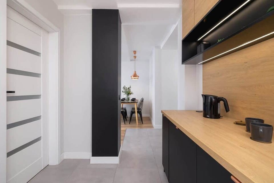 A modern hallway with white doors leading to different rooms.

