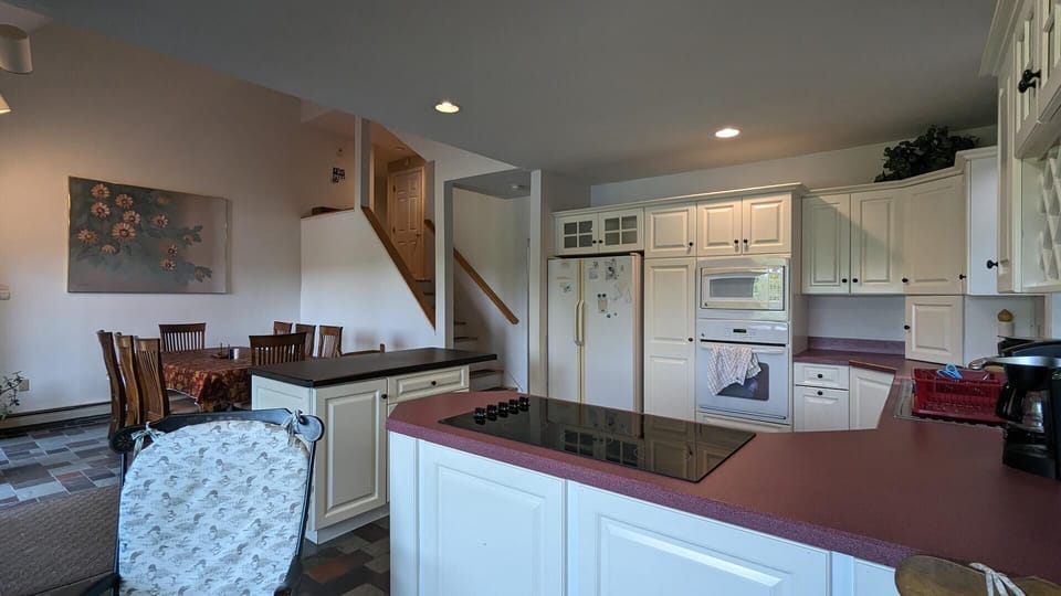 Walk down a small flight of stairs to the kitchen and dining space