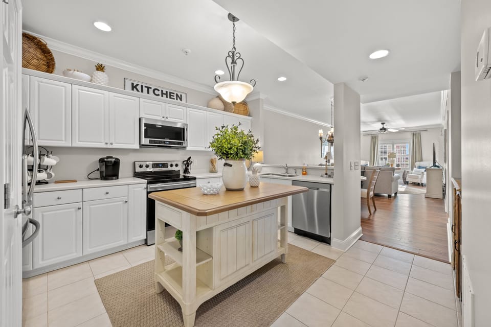 The spacious kitchen is updated & well stocked for preparing family meals.
