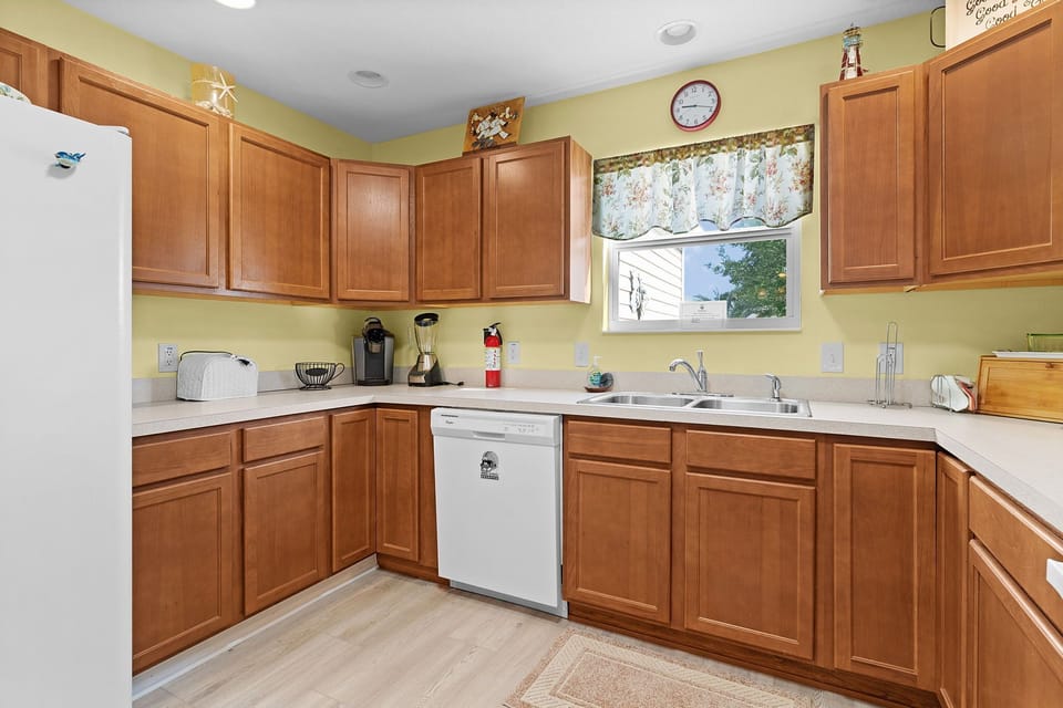 Your fully equipped kitchen features warm wood cabinetry, ample counter space, and everything you need to prepare home-cooked meals during your stay.