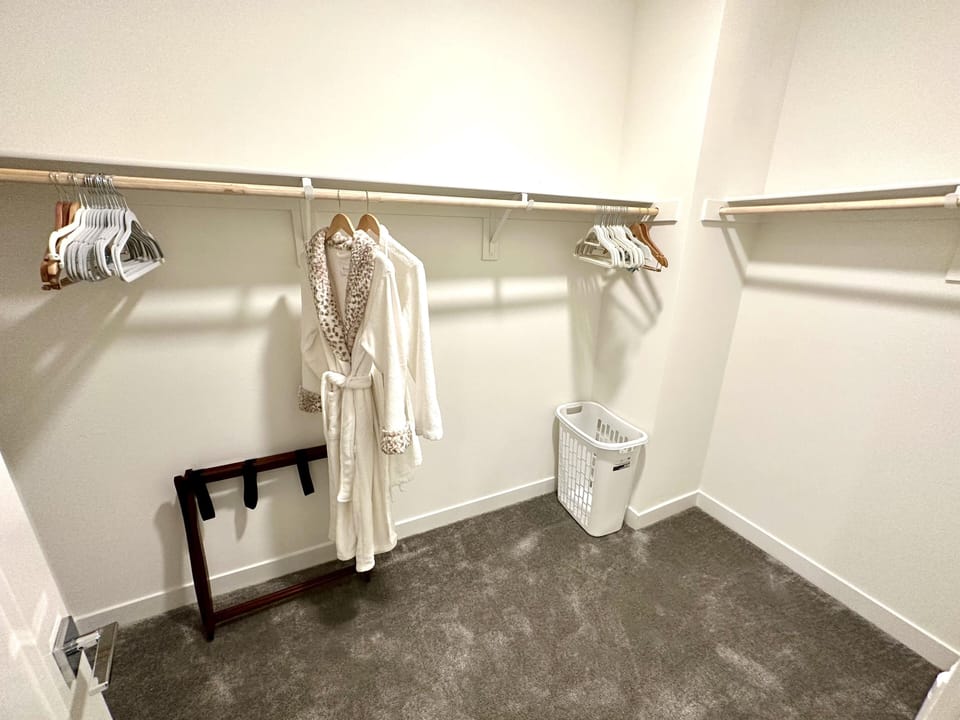 Large master bedroom walk-in closet with his and her bathrobes