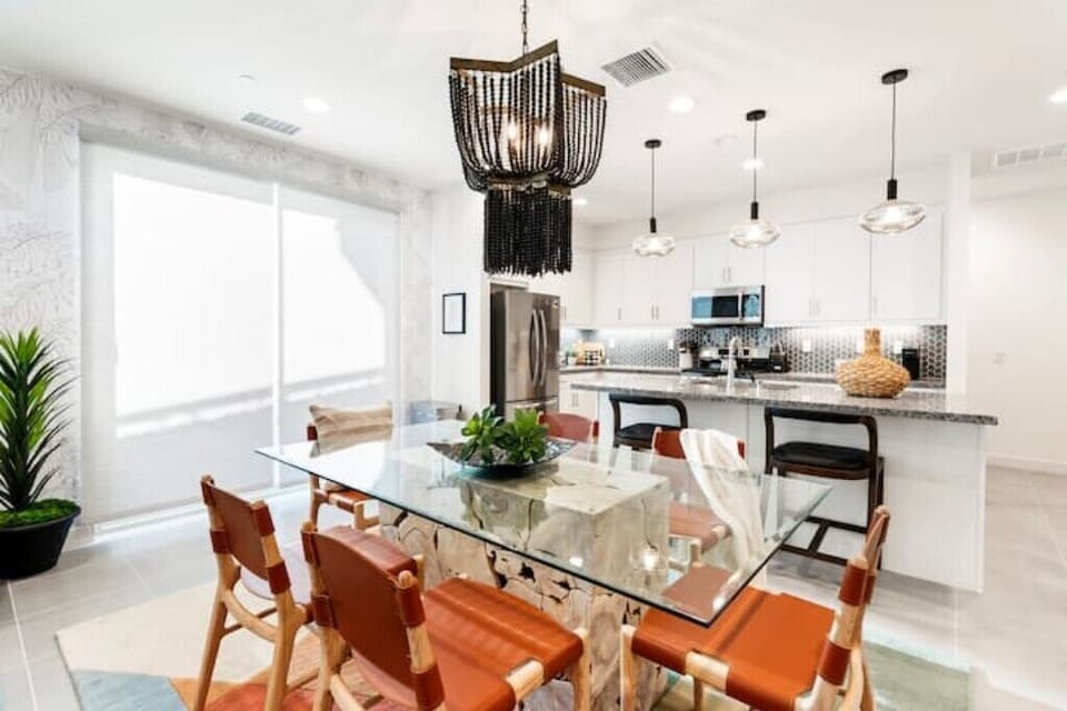The dining area seats six, with two bar stools on the kitchen island.