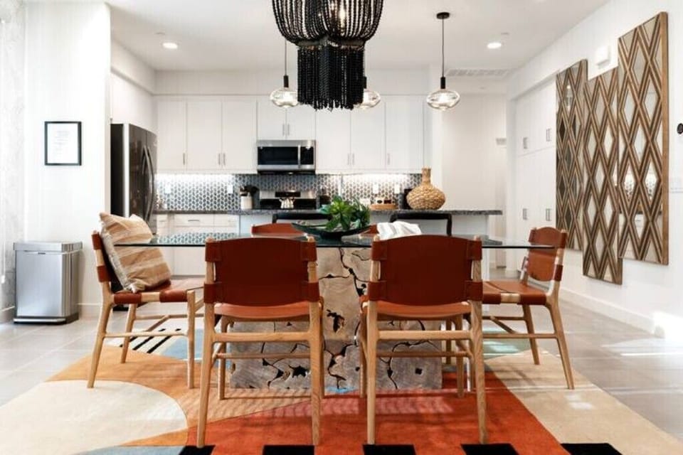 The dining area seats six, with two bar stools on the kitchen island.