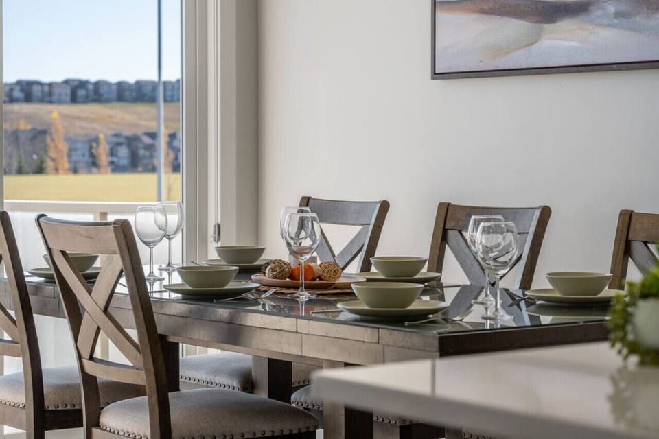 Dining area equipped with all dinner ware, including wine glasses.