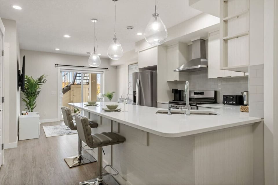 Dining area equipped with all dinner ware, including wine glasses.