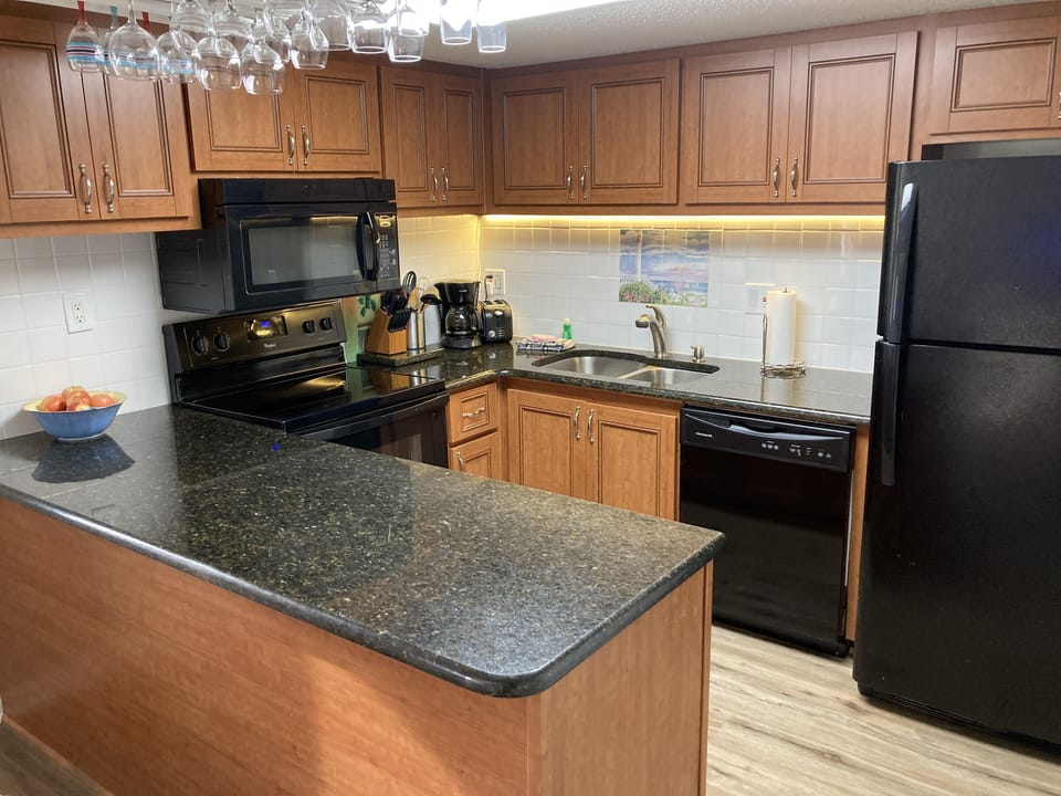 Well stocked kitchen with plenty of cabinets and marble countertops