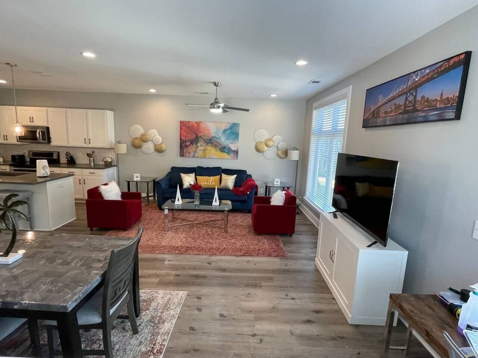 Living Room: Bright and stylish space with vibrant decor, ample seating, and a modern kitchen view!