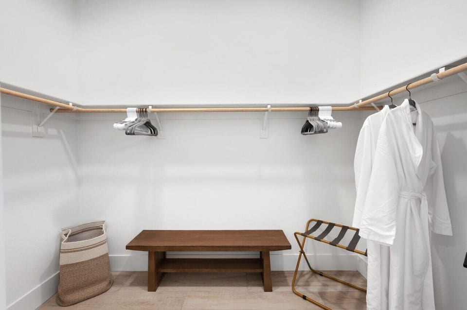 Walk-in closet w/ open shelving & bench for easy storage
