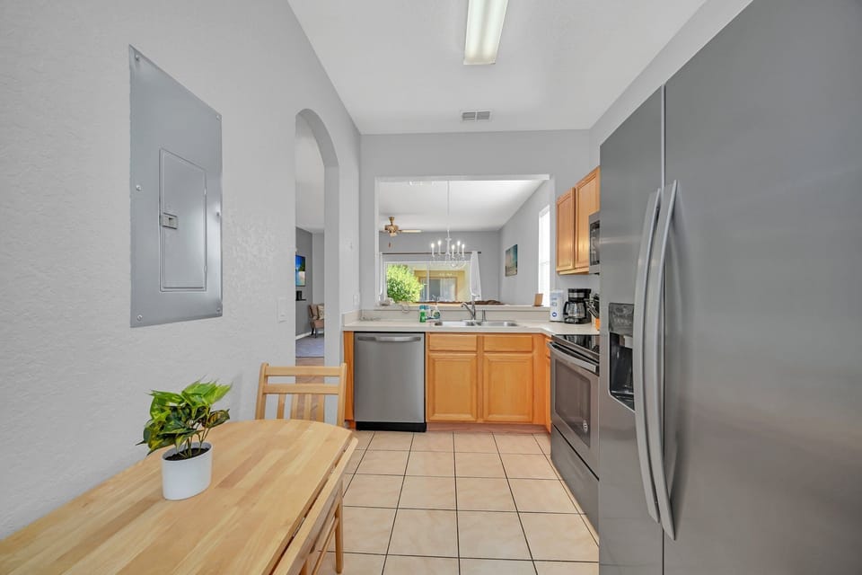 A wider kitchen view showing ample counter space and stainless-steel appliances.